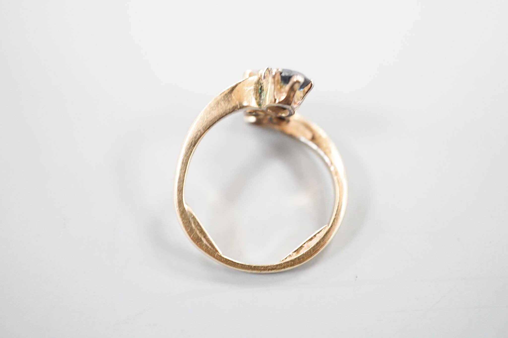 A yellow metal, sapphire an diamond set four stone dress ring, size L, gross 3.4 grams.